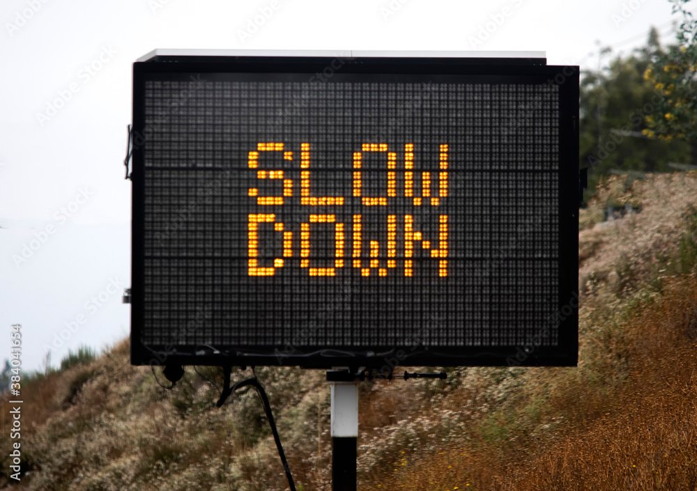 Road Sign Stating Slow Down. Consequences of an Alabama Traffic Ticket.